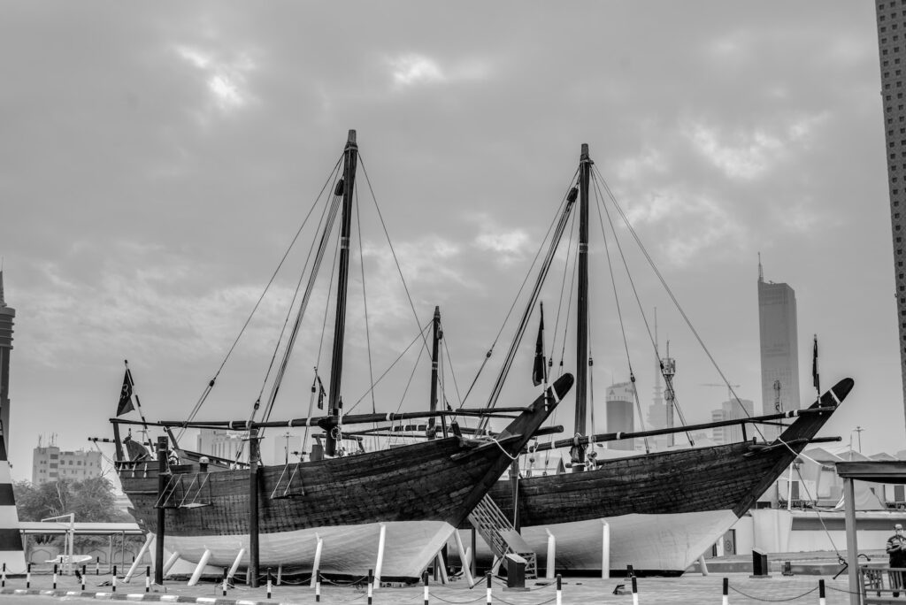 grayscale photo of boat on dock